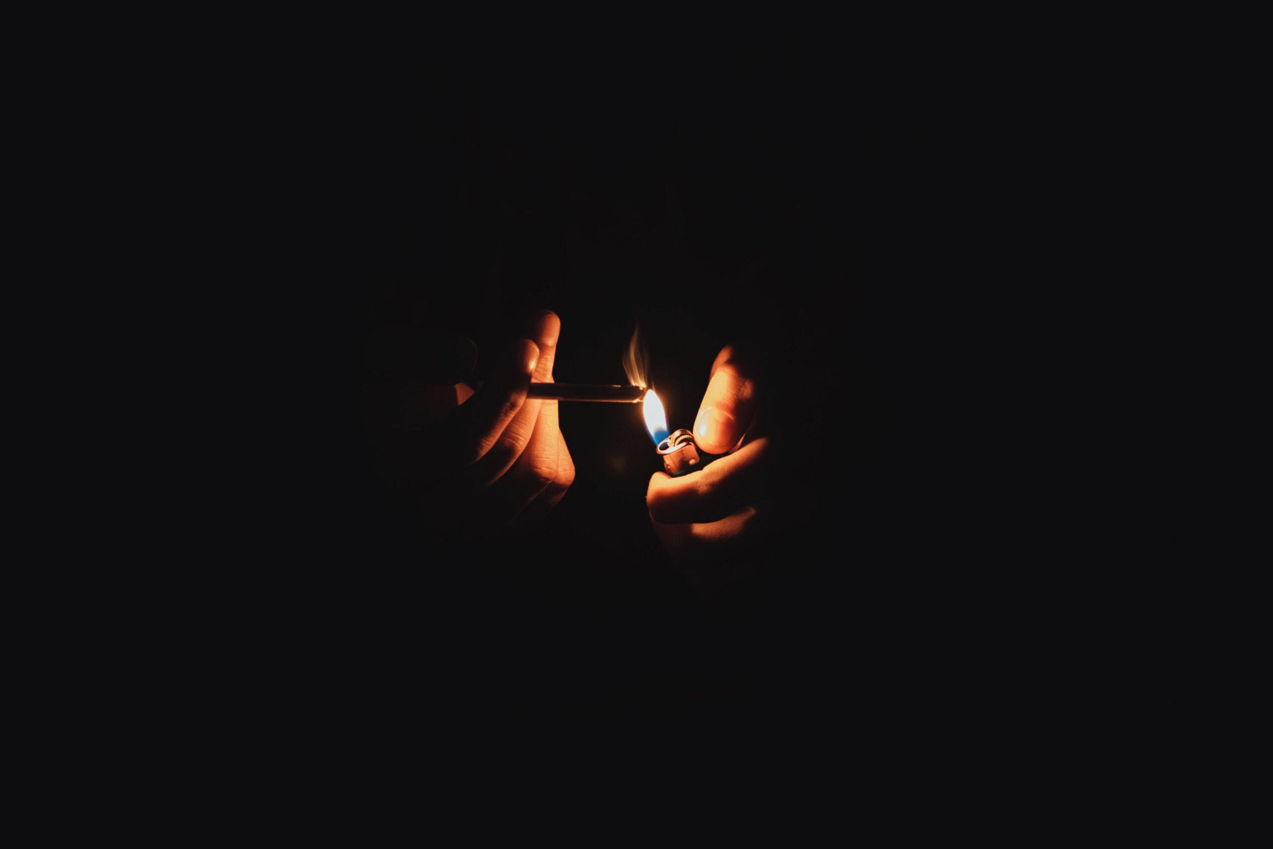 Dark background shot with flame and weed joint