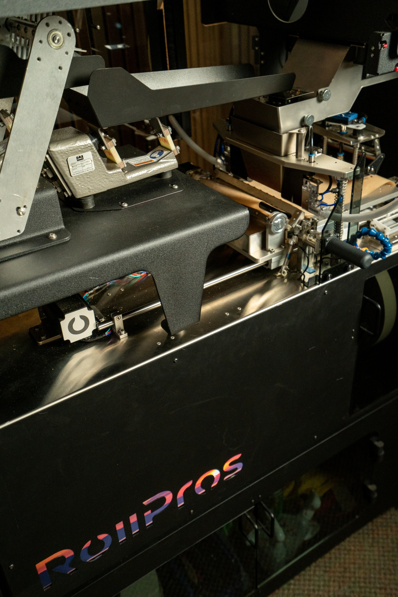 Rollpros' Blackbird automated preroll machine, in motion with a colorful logo on the base.