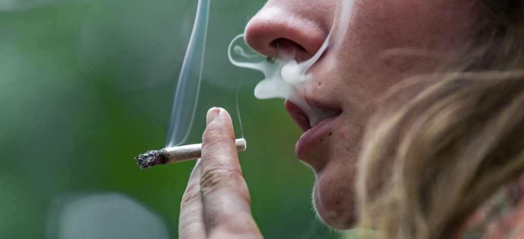 Popular Cannabis Strains in the USA: Types, Effects, and Top Picks for 2026 Cannabis smoker smoking a weed joint