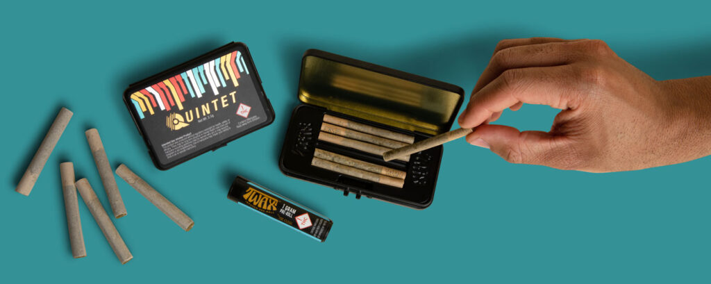 Best Pre Roll Packaging Options: Luxury, Dispensary & Custom Designs prerolls and joint packaging and hand grabbing one out of a tin box package for Twax products