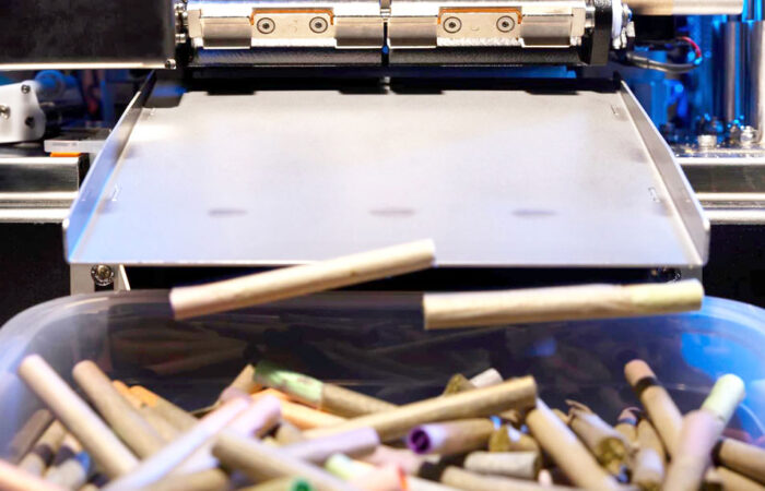 cannabis joints rolling out of a BlackBird automated pre-roll machine