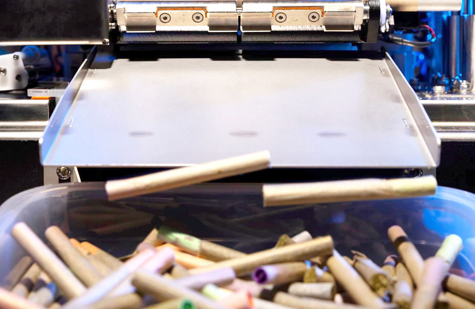 cannabis joints rolling out of a BlackBird automated pre-roll machine