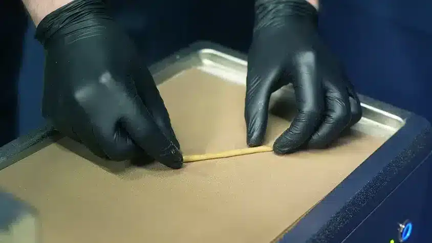 What Are Infused Pre Rolls and Why Are They Gaining Popularity? Operator putting out a worm of hash
