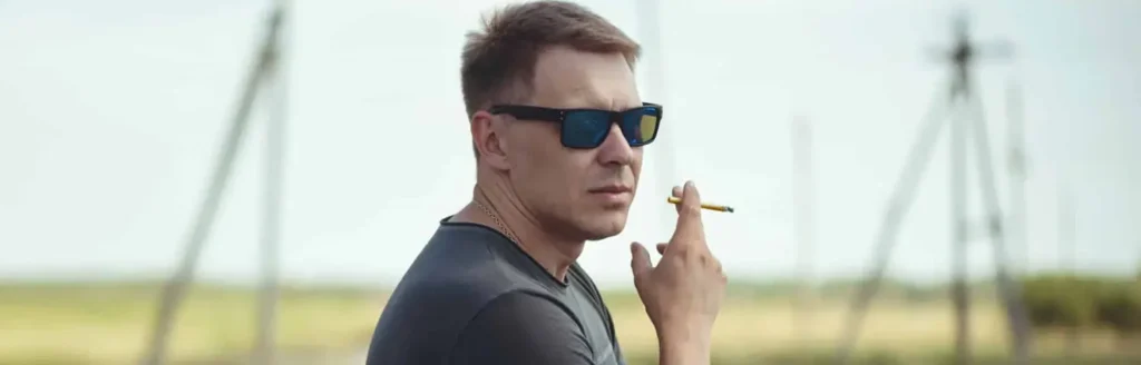 Is Weed Legal in Ohio? (2026 Laws, Limits & What SB 56 Changed) Man smokes in big field